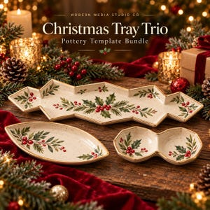 May include: A trio of cream-colored ceramic trays featuring a hand-painted holly and berry pattern with gold-trimmed edges. The set includes one long, angular tray, one oval-shaped dish, and one small, two-sectioned bowl for serving.