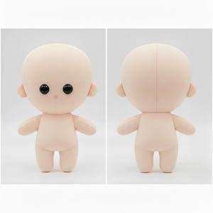 May include: A soft, plush doll with a rounded head, small ears, and a simple body. The doll has black button eyes and a small pink nose. The arms and legs are short and stubby. The doll is a light peach color.