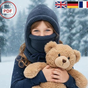 May include: A child wearing a navy blue fleece balaclava and holding a brown teddy bear. The balaclava covers the head, neck, and lower face, with a drawstring closure. The background shows a snowy scene.