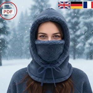 May include: A blue fleece balaclava with a hood and face covering. The balaclava has a drawstring closure and is designed for cold weather. The background shows a snowy scene.