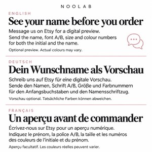 May include: A white informational graphic with black text titled NOOLAB. It provides instructions in English, German, and French on how to request a digital preview for custom name orders, including font, size, and color selection details.
