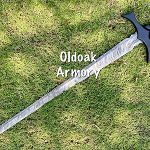 May include: A long, ornate sword with a patterned blade and black hilt, lying on a bed of green grass. The text "Oldoak Armory" is visible on the image. The sword features a crossguard and a detailed handle.