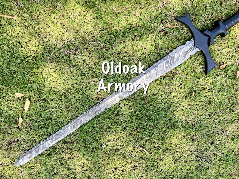 May include: A long, ornate sword with a patterned blade and black hilt, lying on a bed of green grass. The text "Oldoak Armory" is visible on the image. The sword features a crossguard and a detailed handle.