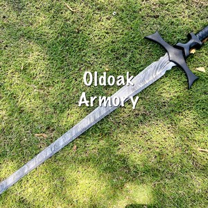 May include: A long, silver and black sword with a textured blade and a black handle. The sword has a crossguard and a rounded pommel. The text "Oldoak Armory" is visible on the image.