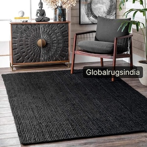 May include: A rectangular black area rug with a woven, textured surface. The rug features a consistent, dense weave pattern throughout. The text Globalrugsindia is visible in the lower right corner of the image, overlaying the rug's surface.
