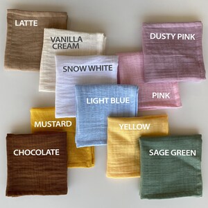 Color palette catalog for organic muslin handkerchiefs. Folded reusable cloth tissues labeled with color names including Latte, Vanilla Cream, Snow White, Light Blue, Mustard, Chocolate, Yellow, Sage Green, Pink, and Dusty Pink.