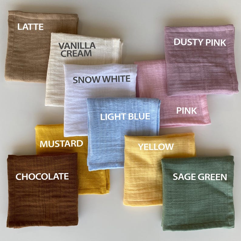 Color palette catalog for organic muslin handkerchiefs. Folded reusable cloth tissues labeled with color names including Latte, Vanilla Cream, Snow White, Light Blue, Mustard, Chocolate, Yellow, Sage Green, Pink, and Dusty Pink.