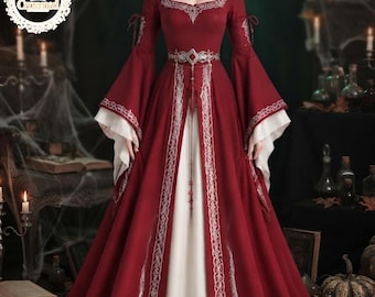 May include: A floor-length deep red gown featuring long flared sleeves with white undersleeves, a square neckline, and an ornate silver-toned belt. The dress is decorated with intricate silver embroidery along the neckline, sleeves, and front panel.