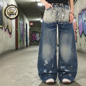 Washed Denim Jeans | Studded Wide Leg Pants | Daily Wear | Y2K Streetwear Style

Washed denim jeans with a wide leg silhouette and studded eyelet detailing, featuring a loose fit suitable for streetwear outfits, casual styling, and everyday wear with a Y2K-inspired look.