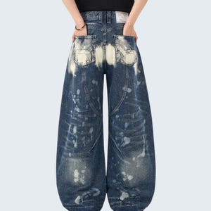 Washed Denim Jeans | Studded Wide Leg Pants | Daily Wear | Y2K Streetwear Style

Washed denim jeans with a wide leg silhouette and studded eyelet detailing, featuring a loose fit suitable for streetwear outfits, casual styling, and everyday wear with a Y2K-inspired look.