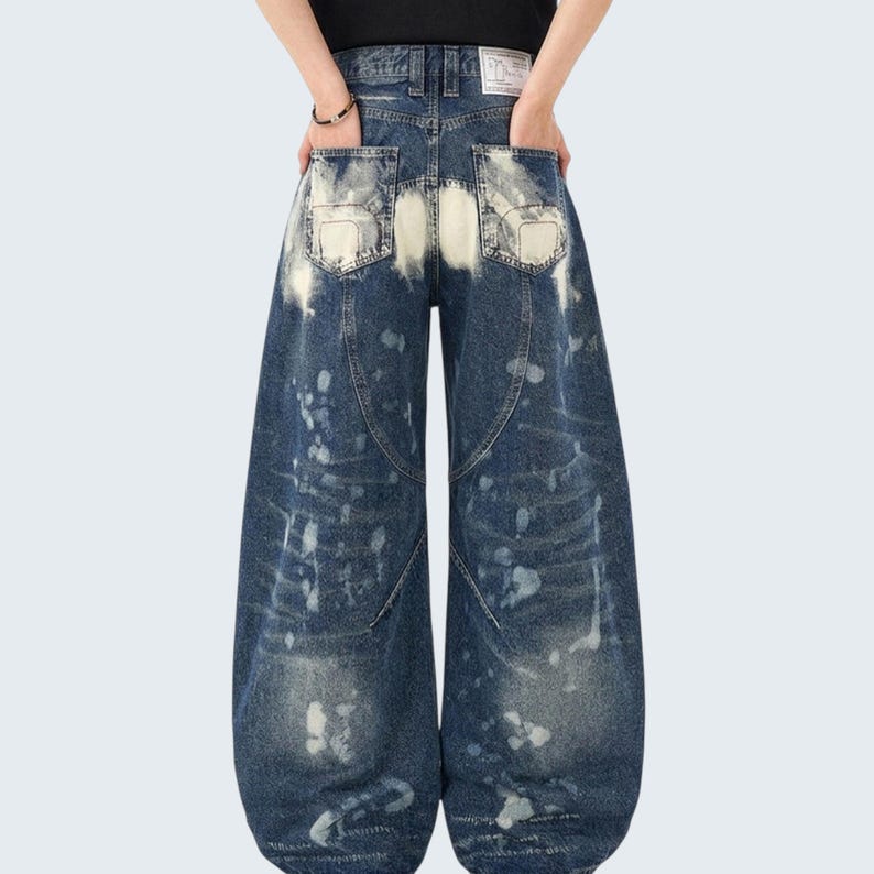 Washed Denim Jeans | Studded Wide Leg Pants | Daily Wear | Y2K Streetwear Style

Washed denim jeans with a wide leg silhouette and studded eyelet detailing, featuring a loose fit suitable for streetwear outfits, casual styling, and everyday wear with a Y2K-inspired look.