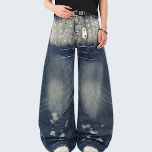 Washed Denim Jeans | Studded Wide Leg Pants | Daily Wear | Y2K Streetwear Style

Washed denim jeans with a wide leg silhouette and studded eyelet detailing, featuring a loose fit suitable for streetwear outfits, casual styling, and everyday wear with a Y2K-inspired look.