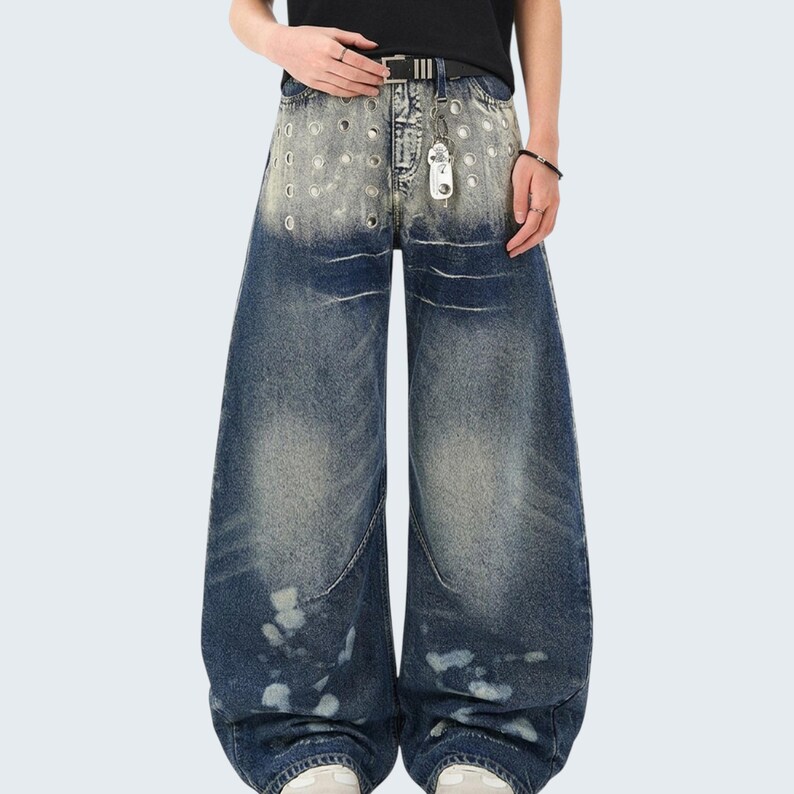 Washed Denim Jeans | Studded Wide Leg Pants | Daily Wear | Y2K Streetwear Style

Washed denim jeans with a wide leg silhouette and studded eyelet detailing, featuring a loose fit suitable for streetwear outfits, casual styling, and everyday wear with a Y2K-inspired look.