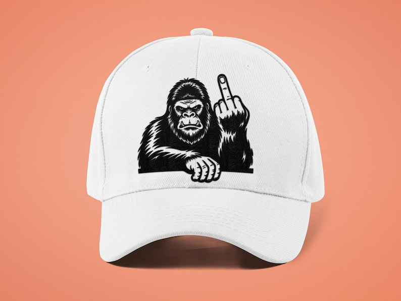 May include: White baseball cap featuring a black and white illustration of a gorilla giving the middle finger. The gorilla is depicted with detailed fur and a stern expression. The cap has a curved brim and a button on top.