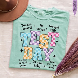 May include: A set of three ceramic mugs with a speckled, matte finish. The mugs are in shades of cream, light gray, and dark gray. Each mug has a simple, minimalist design, perfect for coffee or tea.