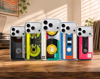 Könnte beinhalten: Fünf transparente Smartphone-Hüllen in einer Reihe, jede mit einem individuellen Retro-Kassetten-Design. Die Motive umfassen schwarze, neongelbe, weiße mit gelben Spulen, blau-orange sowie pinke Farbschemata, jeweils mit sichtbaren Kameraaussparungen.