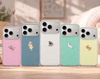 May include: Five smartphone cases arranged in a row, featuring pastel colors including pink, blue, white, mint green, and yellow. Each case displays a small, distinct cartoon dog illustration centered on the back, with a silver camera module.