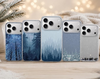 May include: Five clear smartphone cases arranged in a row, each featuring a unique winter-themed design. The designs include dark blue forest silhouettes, snowy pine trees, and light blue gradients with falling snow, all displayed on mobile devices.