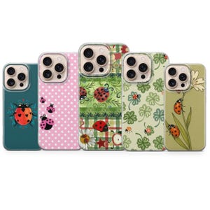 May include: Five phone cases with various designs featuring ladybugs. The cases have different backgrounds, including pink polka dots, green floral patterns, and a teal background with a ladybug illustration. The ladybugs are red and black.