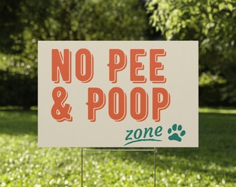 May include: A white sign with the text "NO PEE & POOP zone" in orange and green. A paw print is next to the word "zone".