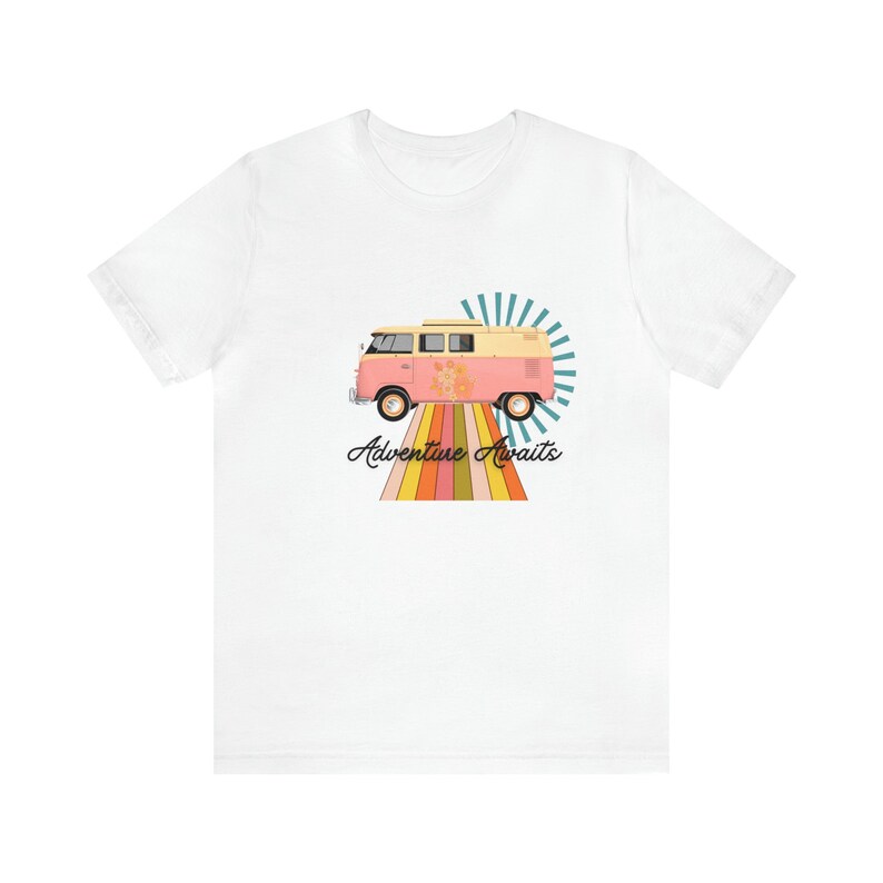 May include: White t-shirt with a pink and yellow vintage van driving on a rainbow road with the text "Adventure Awaits".