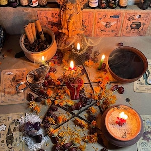 May include: A mystical arrangement featuring a pentagram, candles, and various ritualistic items. The scene includes tarot cards, crystals, dried flowers, and small bottles of essential oils. A wooden bowl holds cinnamon sticks and other botanicals.