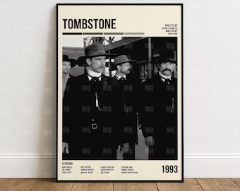 May include: A framed movie poster for the film "Tombstone" featuring a black and white image of several men in suits and hats. The poster includes the film's title, credits, and the year 1993.