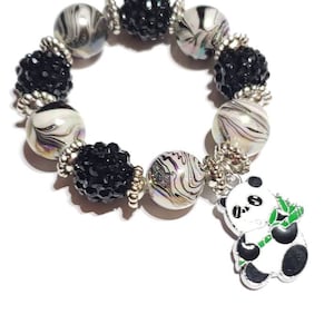 May include: Black and white panda charm bracelet with black and white swirl beads and black crystal beads.