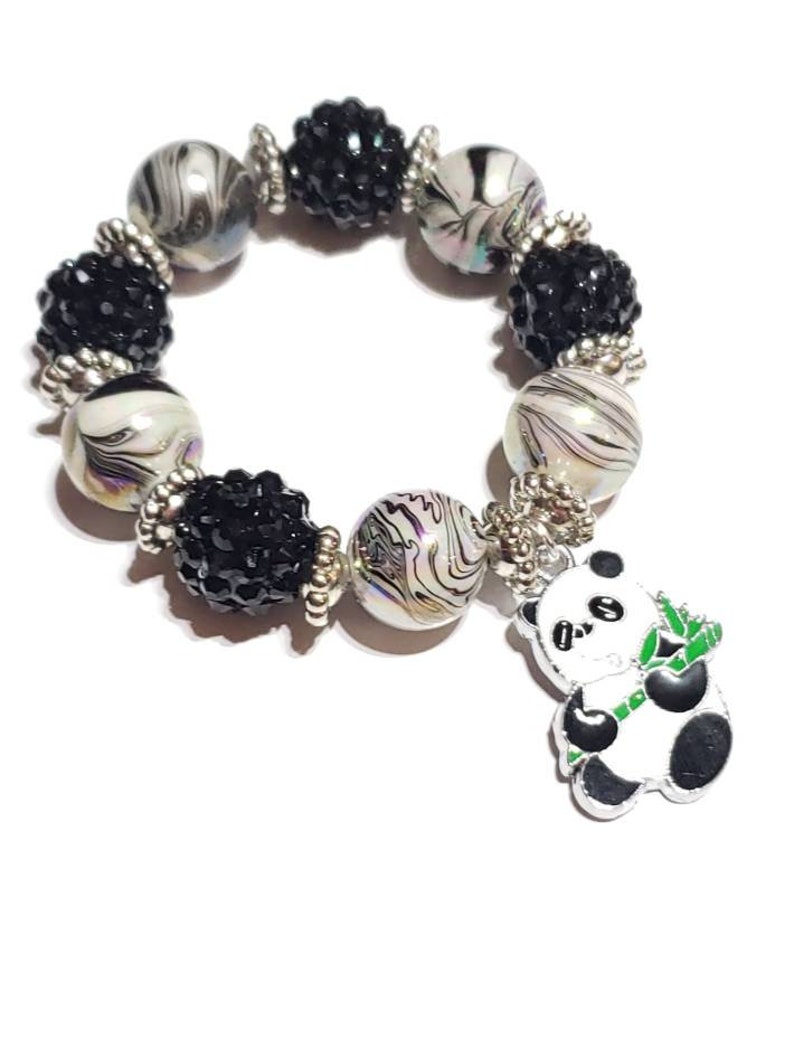 May include: Black and white panda charm bracelet with black and white swirl beads and black crystal beads.