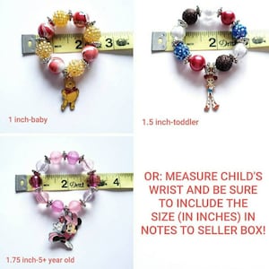 May include: Three colorful beaded bracelets with charms, measured with a tape measure. The bracelets are 1 inch, 1.5 inches, and 1.75 inches in diameter. The charms are Winnie the Pooh, Woody from Toy Story, and Minnie Mouse.