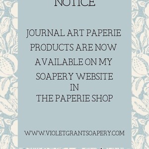 May include: A blue and white floral patterned notice announcing that journal art paperie products are now available on the Soapery website in the Paperie Shop. The website address is www.violetgrantsoapery.com. The notice also states that customers can get a 10% discount when they purchase from the website using the code PAPERIE.