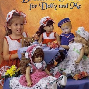 May include: Book cover titled "Dresses to Crochet for Dolly and Me" with a young girl and dolls wearing crocheted dresses and hats. The cover has a warm, orange background. The dolls are dressed in red, white, blue, and pink crochet outfits.