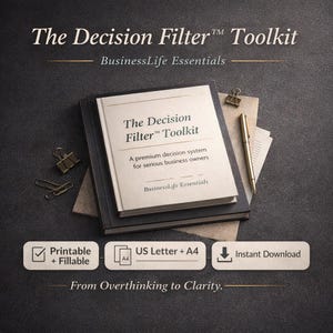 May include: A stack of books titled "The Decision Filter Toolkit" with the tagline "BusinessLife Essentials." The book has a cream-colored cover with black text. Additional office supplies include a gold pen and paper clips.
