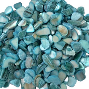 May include: A pile of polished, irregularly shaped stones in shades of teal, turquoise, and off-white. The stones have a glossy, reflective surface, with some displaying subtle patterns and veining. The overall effect is a cool, aquatic aesthetic.