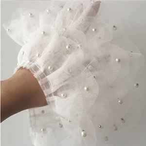 May include: A set of three ceramic mugs with a speckled, matte finish. Each mug features a different color: light blue, cream, and gray. The mugs have a simple, modern design and a comfortable handle.