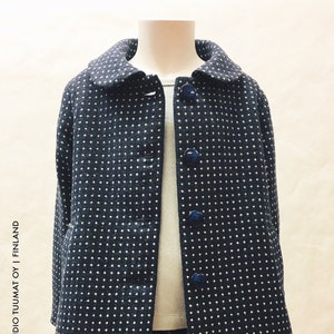 May include: A black and white polka dot coat with a Peter Pan collar and button closure. The coat is made of a soft, textured fabric.