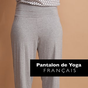 May include: Grey yoga trousers with a wide waistband and cuffed ankles. The trousers are made of a soft, stretchy fabric and are ideal for yoga, Pilates, or other workouts. The text "Pantalon de Yoga FRANÇAIS" is printed on a black rectangle in the centre of the image.