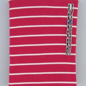 May include: A close-up of a pink and white striped fabric. The fabric is a knit and has a soft, stretchy feel. The stripes are about 1 inch wide.