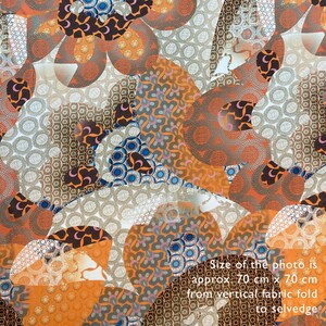 May include: A close-up of a fabric with a repeating pattern of orange, brown, white, and blue circles and swirls. The fabric is approximately 70 cm x 70 cm.