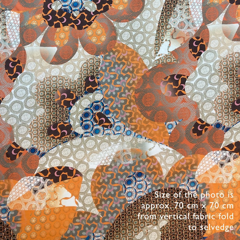 May include: A close-up of a fabric with a repeating pattern of orange, brown, white, and blue circles and swirls. The fabric is approximately 70 cm x 70 cm.