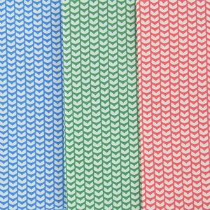 May include: Three fabric swatches with a repeating chevron pattern. The swatches are in blue, green, and red. The chevron pattern is white. The fabric is likely cotton or a similar material.