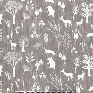 May include: A gray fabric with a white repeating pattern of woodland animals, trees, and plants. The pattern includes deer, bears, rabbits, mushrooms, and various types of foliage.