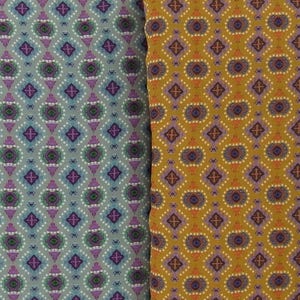 May include: Two fabric samples with repeating geometric patterns. One is a pale blue with purple, green, and white details. The other is mustard yellow with purple, orange, and white details. The patterns feature diamond shapes and floral-like motifs.