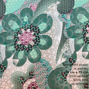 May include: A green and pink floral fabric with a white geometric pattern. The fabric is 70 cm x 70 cm from the vertical fabric fold to the selvedge.