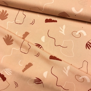 May include: A beige fabric with a repeating pattern of abstract shapes and lines in shades of brown and white.