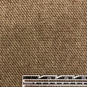 Puede incluir: Primer plano de una tela marr&oacute;n con un sutil patr&oacute;n de espiga. La tela es texturizada y tiene un tacto ligeramente rugoso. Una regla se coloca en la parte inferior de la imagen, mostrando medidas en pulgadas y cent&iacute;metros.