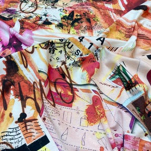 May include: A colorful fabric with a white background featuring a collage of abstract shapes, handwritten text, and stamps. The fabric has a vintage, distressed look and includes the words "USA" and "Air Mail".