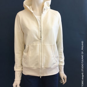 May include: A white hooded sweatshirt with a zip fastening. The sweatshirt has a kangaroo pocket and ribbed cuffs and hem.