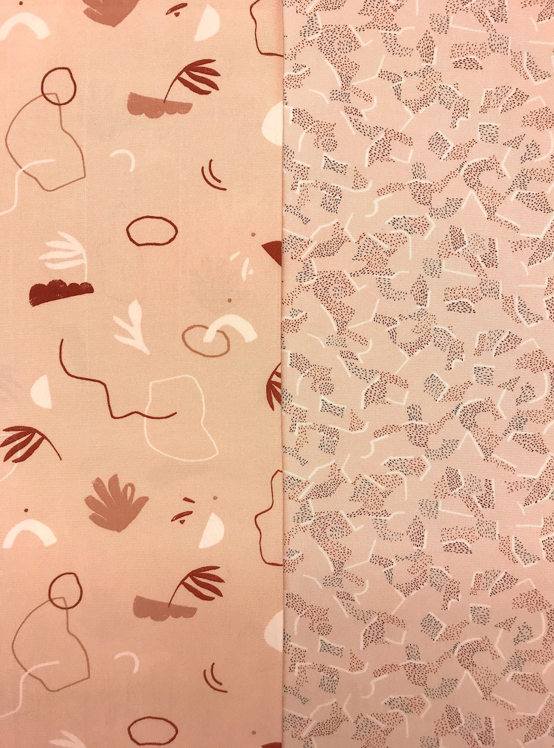 May include: Two fabric swatches with different patterns. The left swatch has a pink background with abstract shapes and lines in brown and white. The right swatch has a pink background with a brown and white speckled pattern.