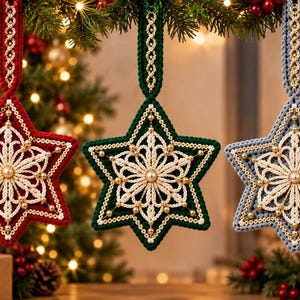 May include: Three star-shaped ornaments in red, dark green, and light blue. Each features a central cream-colored crocheted snowflake pattern, gold bead accents, and a matching crocheted hanging loop with a decorative braided center detail.